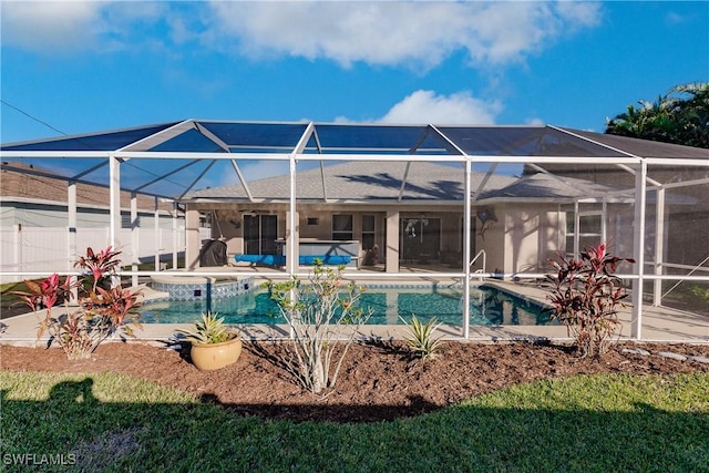 view of swimming pool featuring an in ground hot tub and a lanai