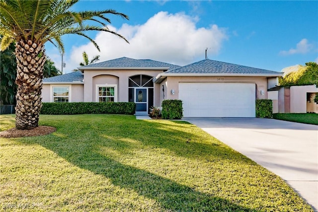 view of front facade featuring a garage and a front lawn