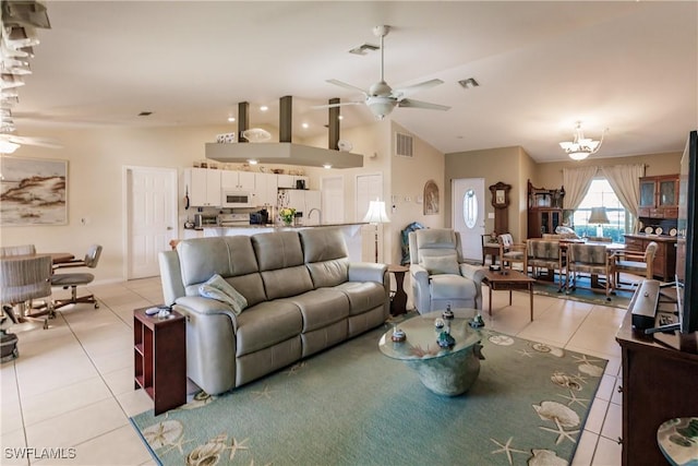 living room with light tile patterned floors, ceiling fan with notable chandelier, and lofted ceiling