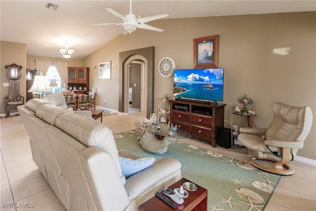 tiled living room featuring ceiling fan with notable chandelier and vaulted ceiling