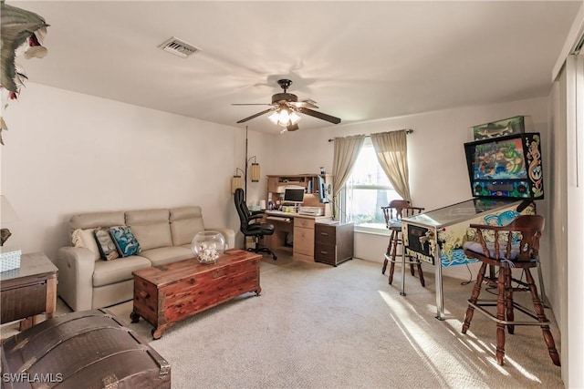 carpeted living room with ceiling fan