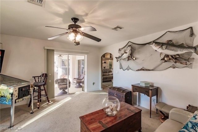 living room with ceiling fan and light colored carpet