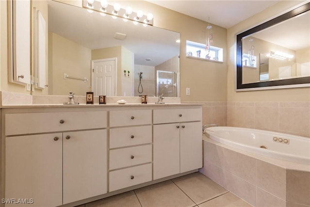 bathroom featuring vanity, a relaxing tiled tub, and tile patterned floors