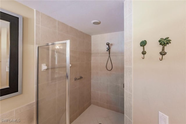 bathroom with tiled shower