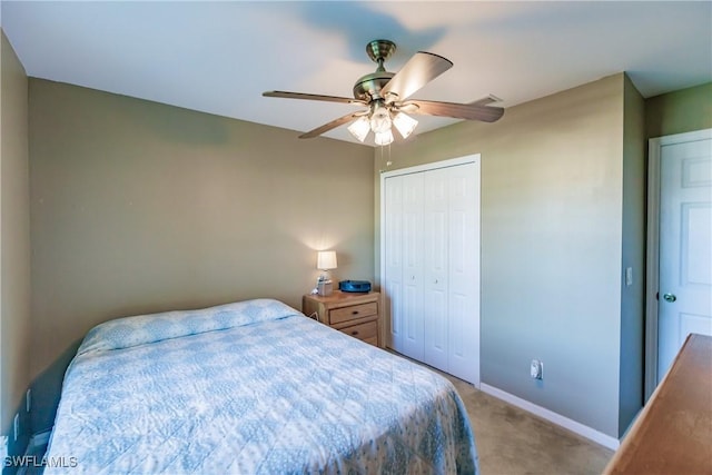 bedroom with ceiling fan, carpet floors, and a closet