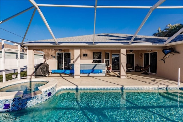 view of pool with an in ground hot tub, a patio, ceiling fan, and a lanai