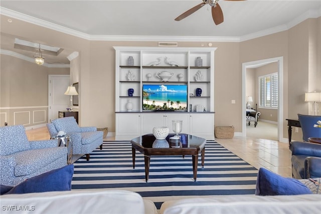 living room with light tile patterned floors, crown molding, and ceiling fan