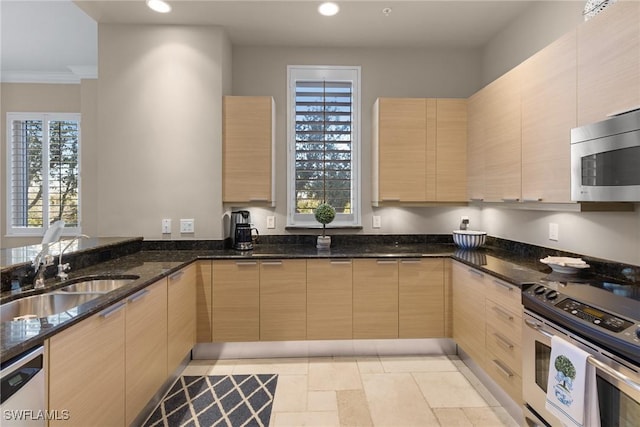 kitchen with sink, stainless steel appliances, ornamental molding, light brown cabinetry, and dark stone counters