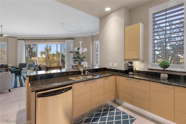 kitchen featuring sink, stainless steel dishwasher, dark stone counters, and kitchen peninsula