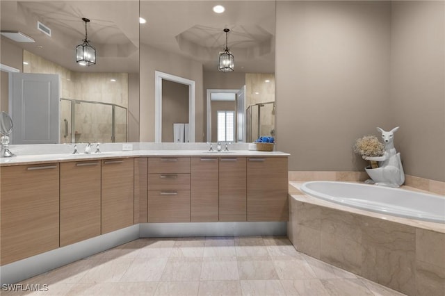 bathroom featuring vanity and separate shower and tub