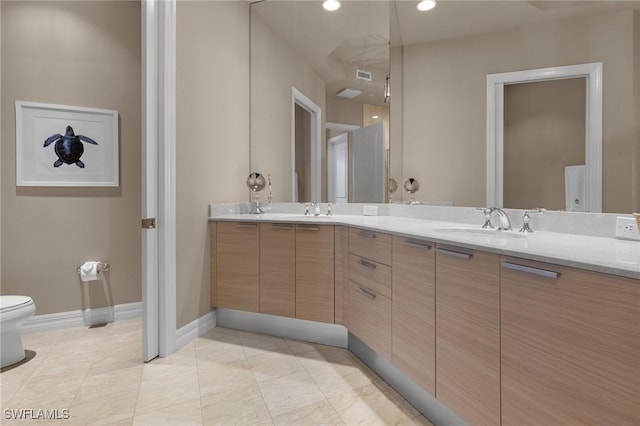 bathroom featuring vanity, tile patterned floors, and toilet