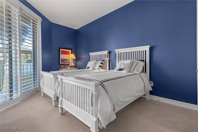 bedroom featuring light colored carpet