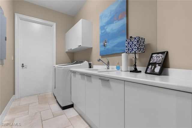 laundry room featuring cabinets, sink, and independent washer and dryer