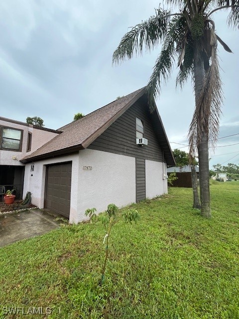 view of property exterior with a yard and a garage