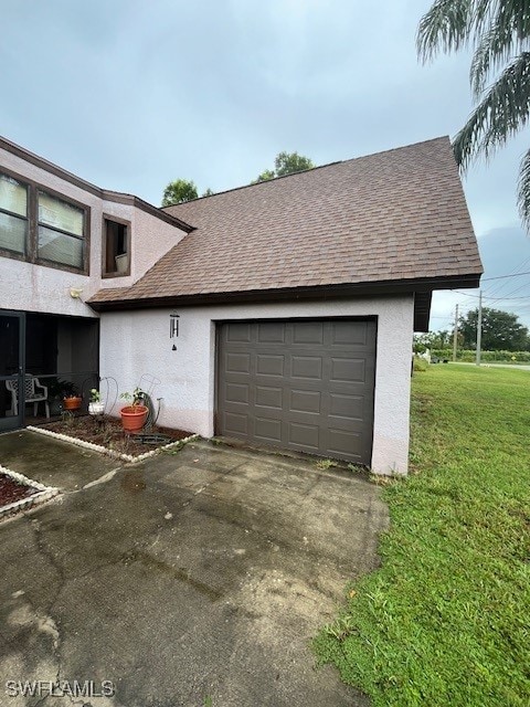 garage featuring a lawn