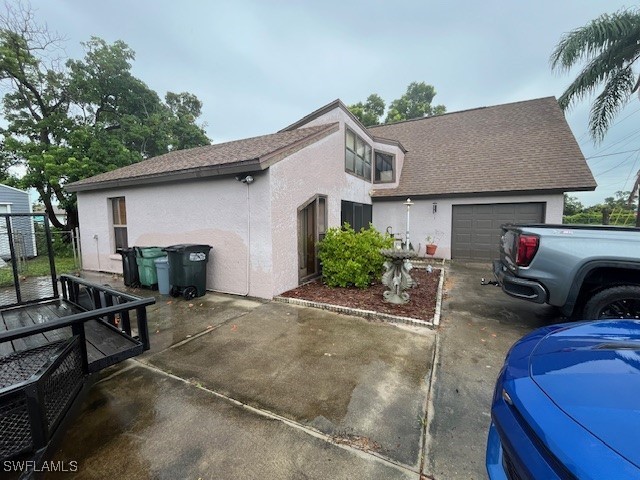 exterior space with a garage and an outdoor structure