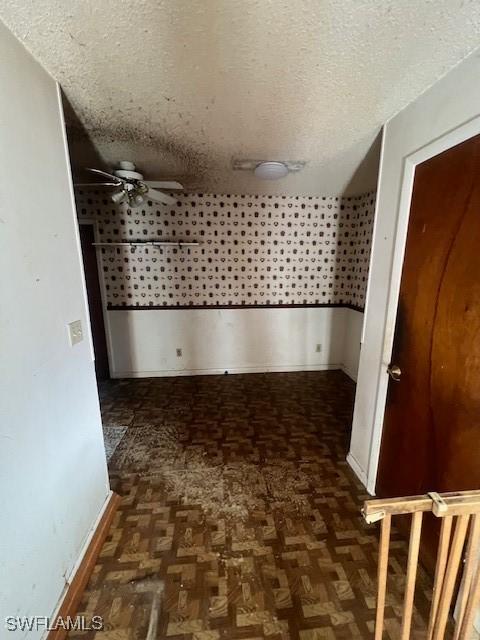 hallway featuring a textured ceiling