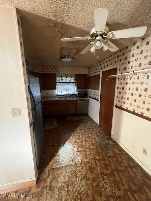 kitchen with ceiling fan, sink, and stainless steel appliances