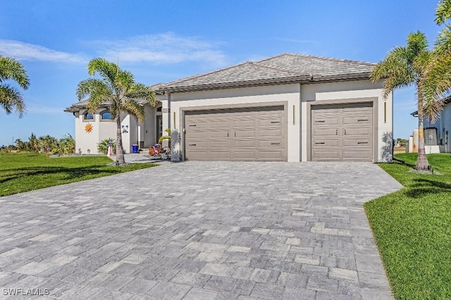 view of front of property with a garage and a front lawn