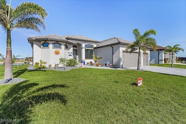 mediterranean / spanish-style house featuring a front yard and a garage