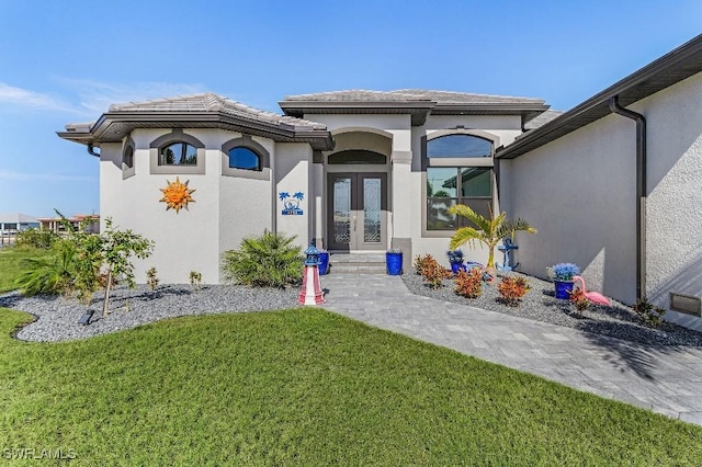 view of front of property featuring french doors and a front yard