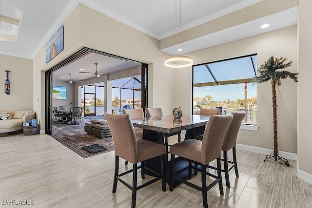 dining space featuring ceiling fan, crown molding, and a healthy amount of sunlight