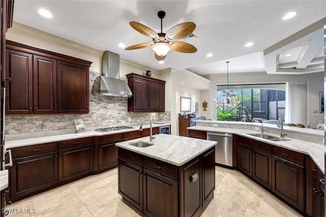 kitchen featuring sink, backsplash, wall chimney exhaust hood, and stainless steel appliances