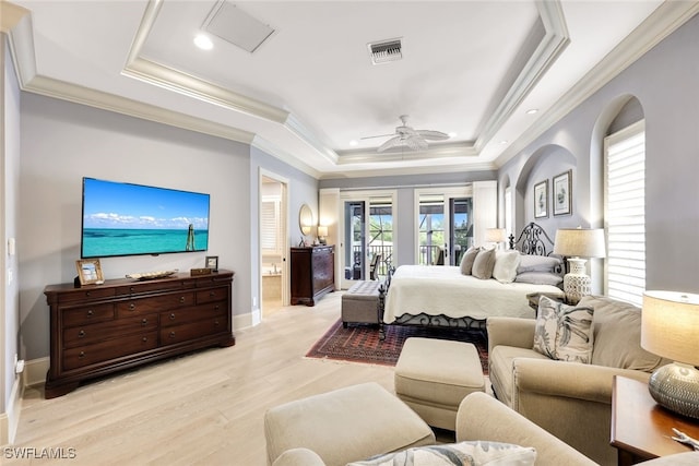 bedroom with light hardwood / wood-style floors, access to exterior, a raised ceiling, ceiling fan, and crown molding