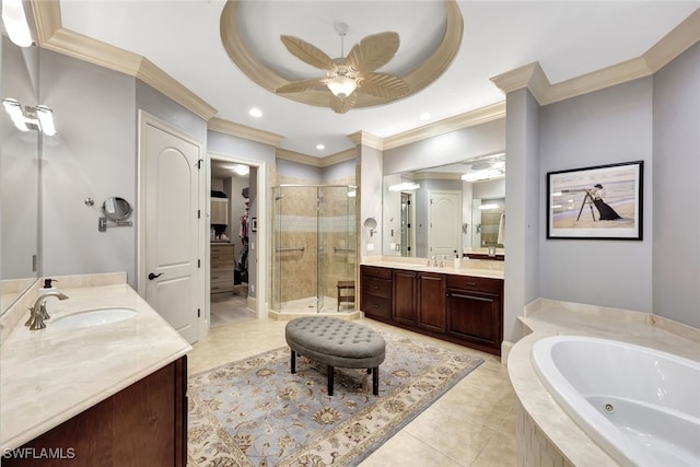 bathroom featuring separate shower and tub, vanity, ceiling fan, a tray ceiling, and ornamental molding