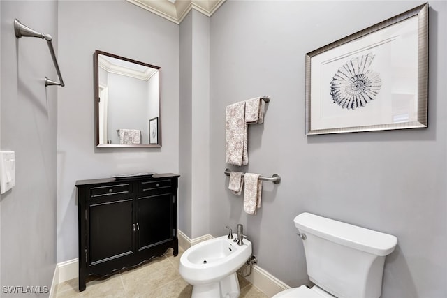 bathroom with ornamental molding, toilet, vanity, and a bidet