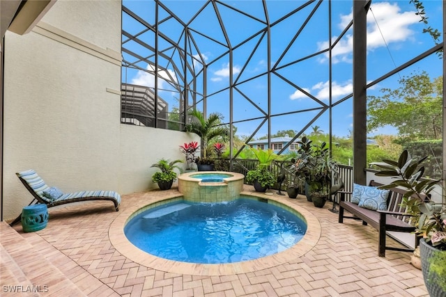 view of swimming pool with an in ground hot tub, a lanai, and a patio