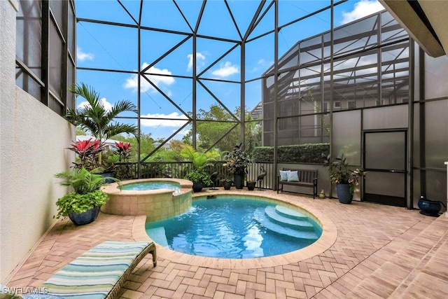 view of swimming pool featuring a lanai, an in ground hot tub, and a patio