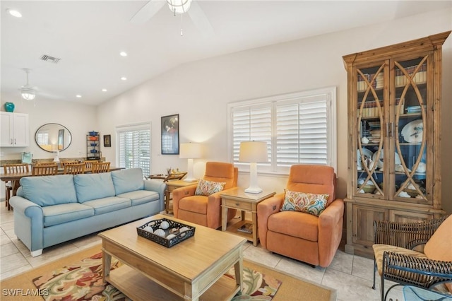 tiled living room with ceiling fan and lofted ceiling