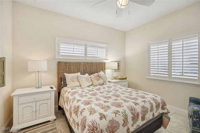 tiled bedroom featuring multiple windows and ceiling fan