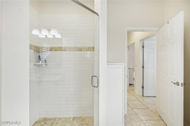 bathroom featuring tile patterned floors and a shower with shower door