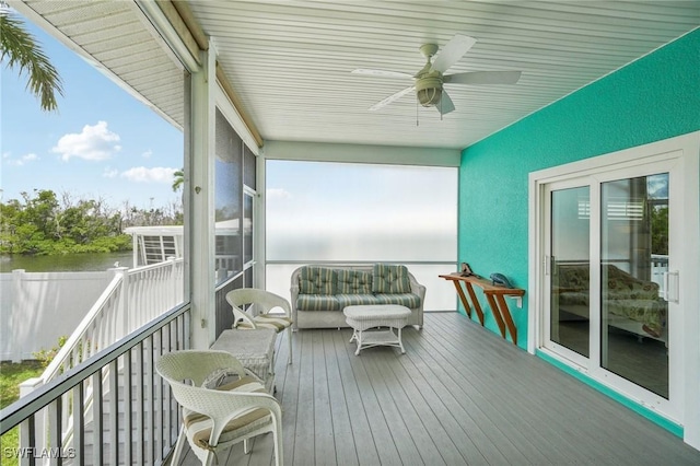 exterior space featuring ceiling fan and a water view