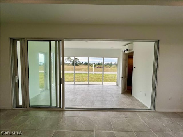 interior space with light tile patterned floors and a wall unit AC