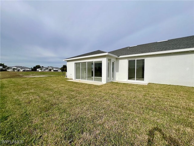 rear view of house with a yard