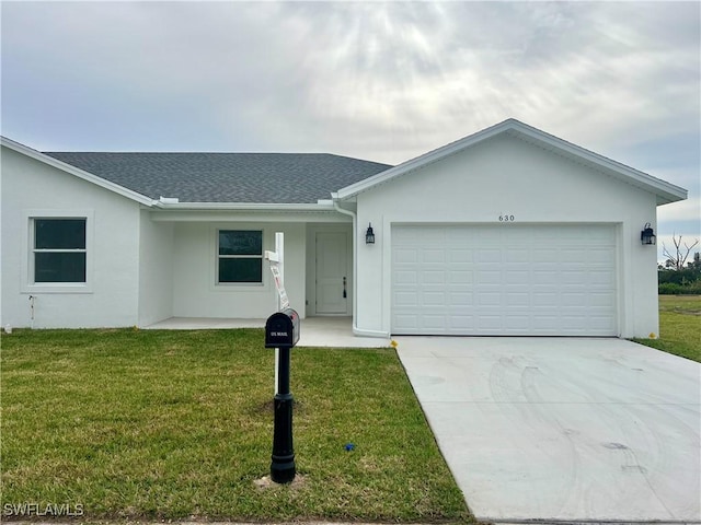 single story home with a front yard and a garage