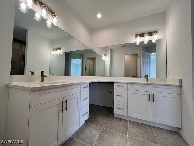 bathroom with tile patterned floors and vanity