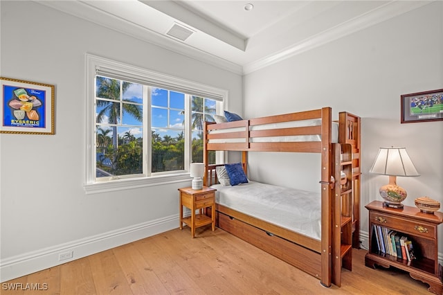 bedroom with light hardwood / wood-style floors and crown molding