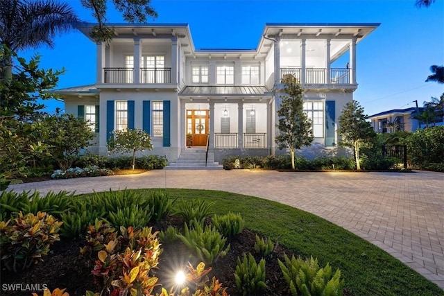 view of front facade featuring a balcony and french doors