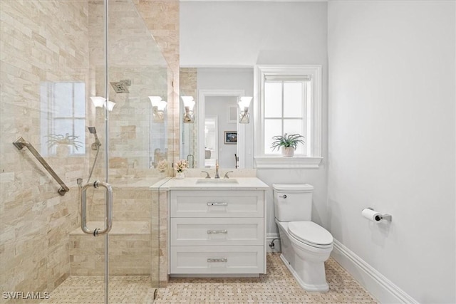 bathroom with vanity, toilet, and a shower with shower door