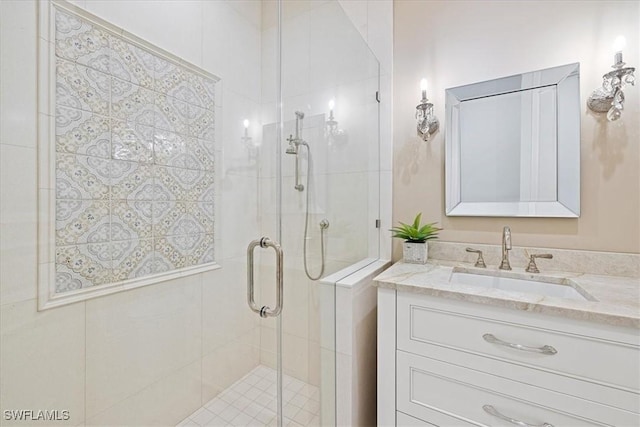 bathroom featuring vanity and an enclosed shower