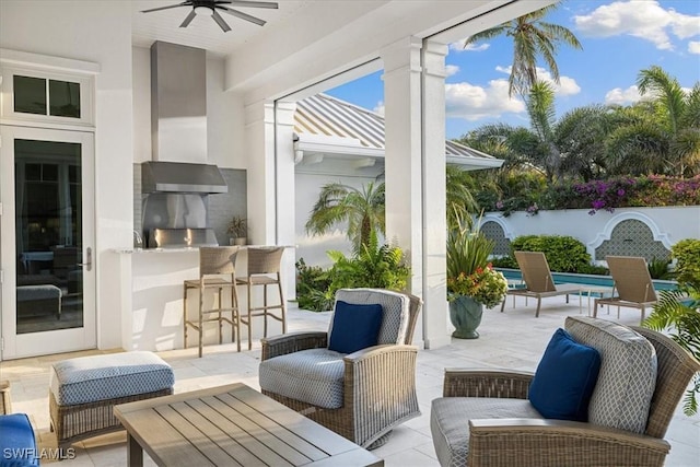 view of patio with exterior bar and ceiling fan