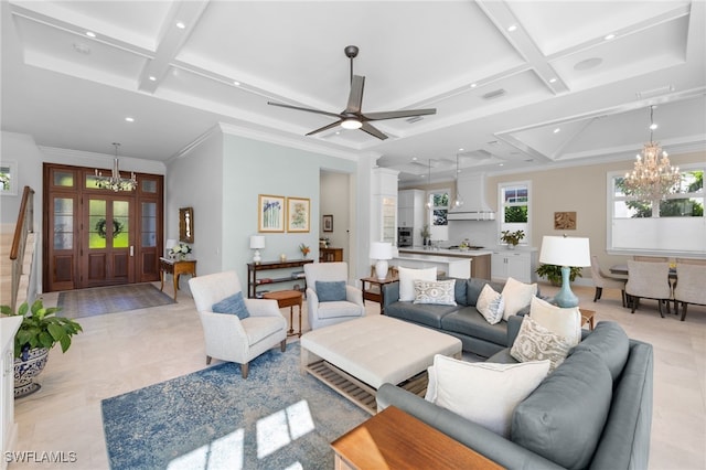 living room featuring ceiling fan with notable chandelier, beam ceiling, ornamental molding, and coffered ceiling