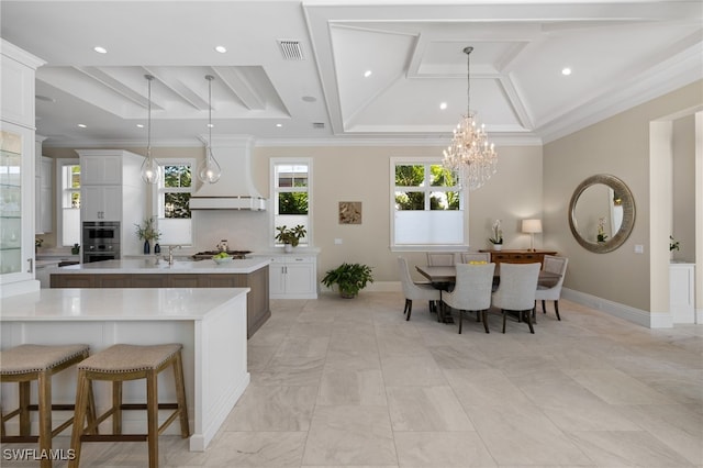 kitchen with white cabinetry, a large island, and pendant lighting