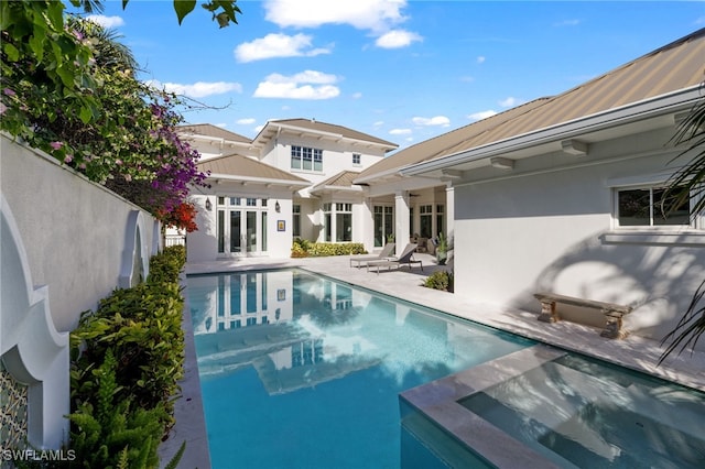 view of swimming pool with french doors and a patio