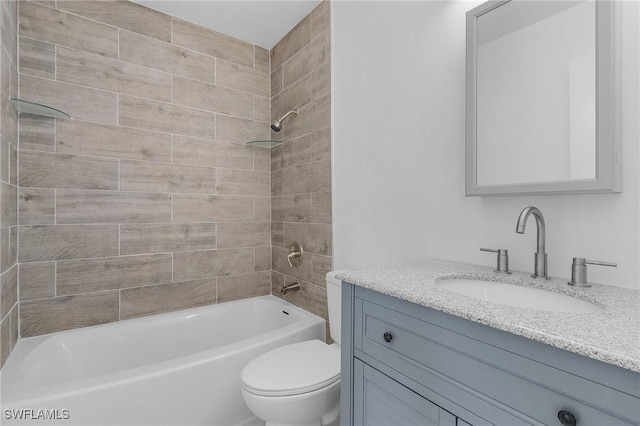 full bathroom featuring toilet, vanity, and tiled shower / bath