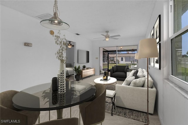 tiled living room with ceiling fan